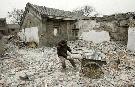 A worker mines the remains of a bulldozed courtyard house for bricks Jason Lee / Reuters 