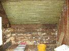 Upper Bedroom interior, lined with newspapers and wallpaper