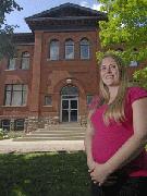 Kayla Jonas stands in front of the old Carnegie Library at 40 Albert St., Waterloo, one of the hundreds of properties documented on the website Building Stories.