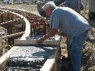 Bell Barn Society -Smoothing the concrete in the new grade beam. (Source: Dayle Bowman)