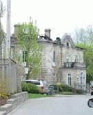 The Manor Park mansion is without a roof following a house fire that began on Tuesday. This photo was taken Wednesday afternoon.