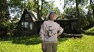 Eurithe in front of A frame dwelling she built with husband Al Purdy