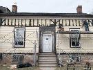 John Rennison/The Hamilton Spectator - Johnny Overbeeke and Doug Vickers work on the front of the house, hoping to have new clapboard up next month, with a fresh coat of paint.