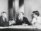 Philip Johnson, Ludwig Mies van der Rohe and Phyllis Lambert in front of an image of the model for the Seagram building, New York, 1955. Fonds Phyllis Lambert, Canadian Centre for Architecture, Montreal. © United Press International